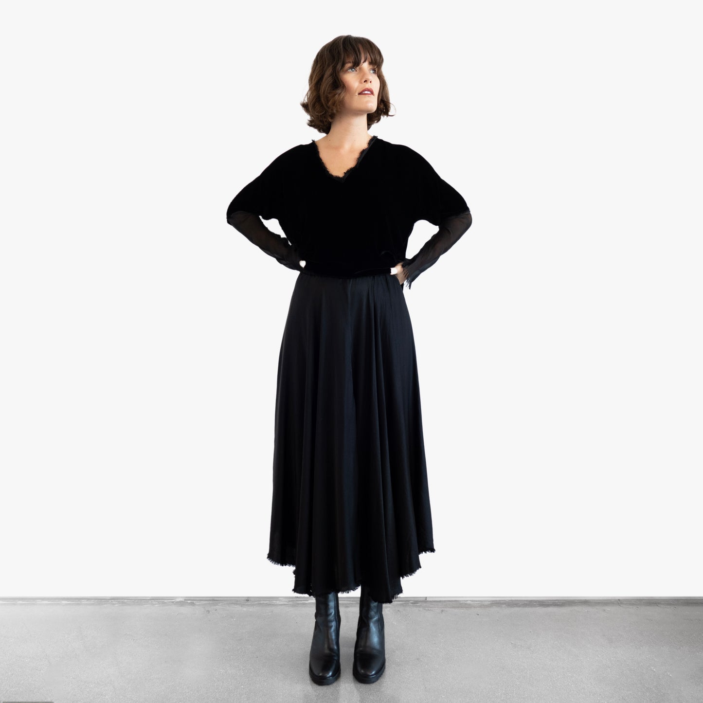 Model wearing a black velvet blouse and black silk skirt