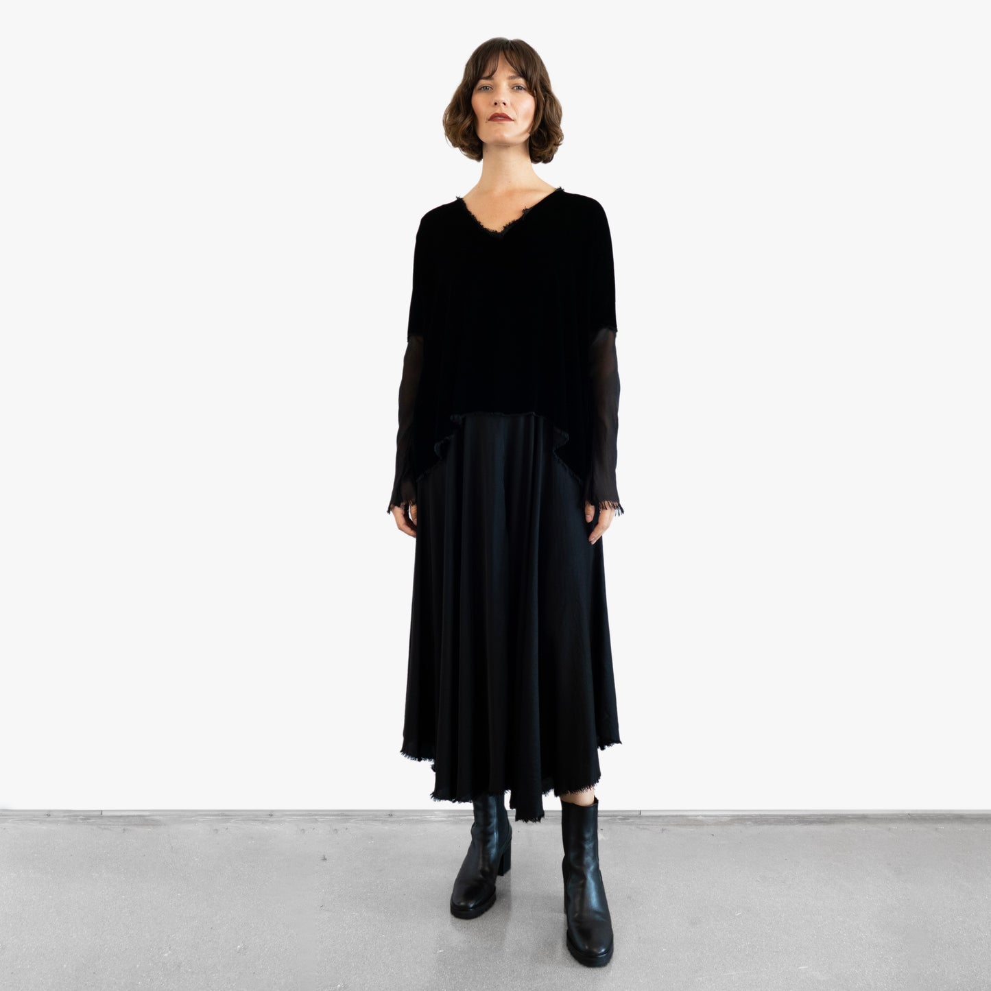 Model wearing a black velvet blouse and black silk skirt