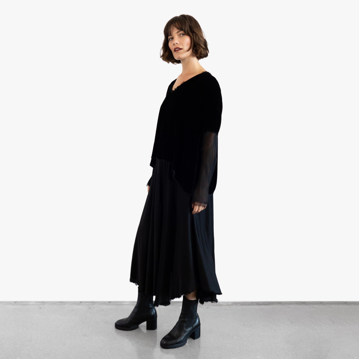 Model wearing a black velvet blouse and black silk skirt