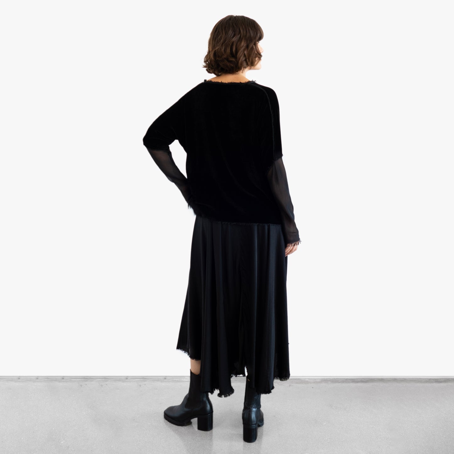 Model wearing a black velvet blouse and black silk skirt