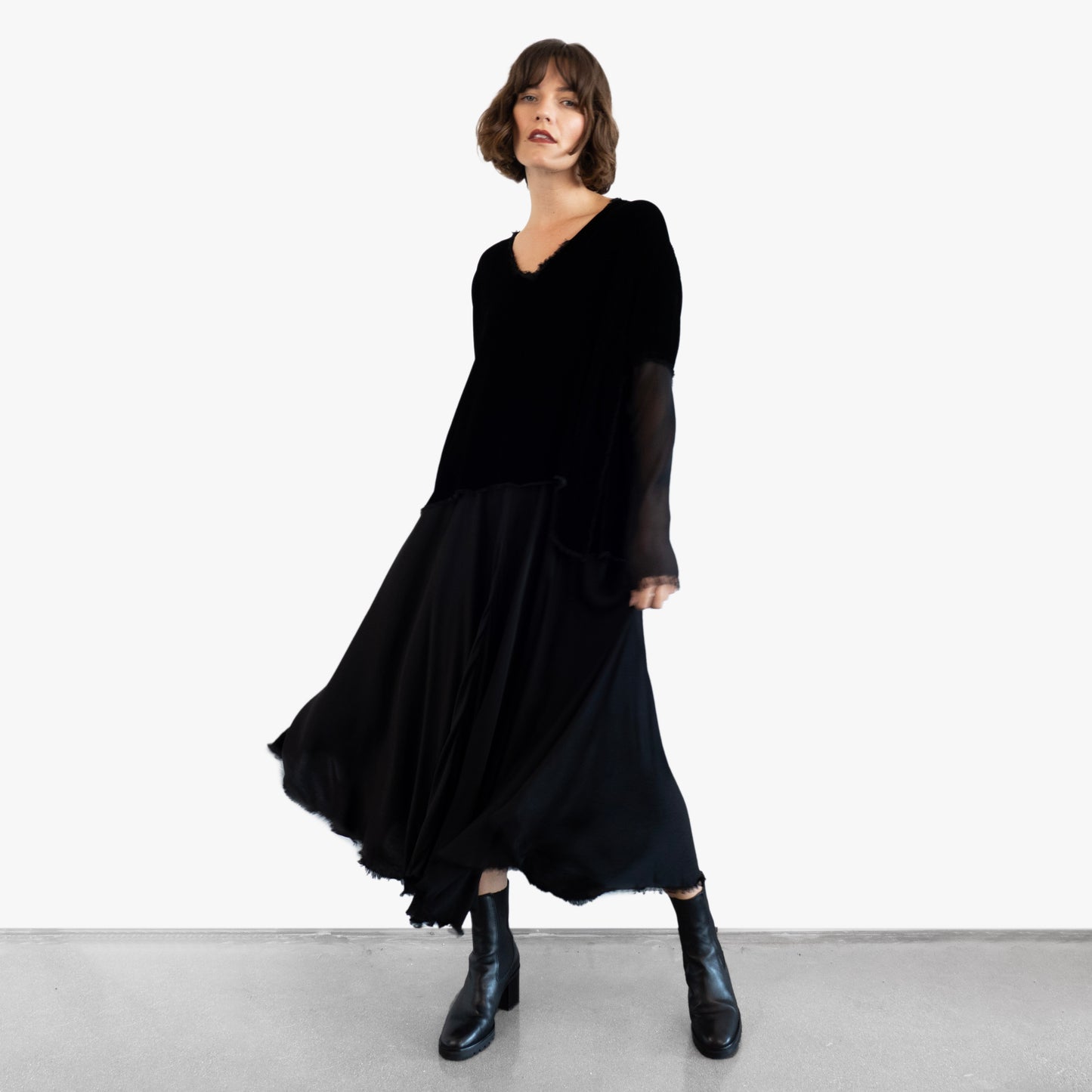 Model wearing a black velvet blouse and black silk skirt