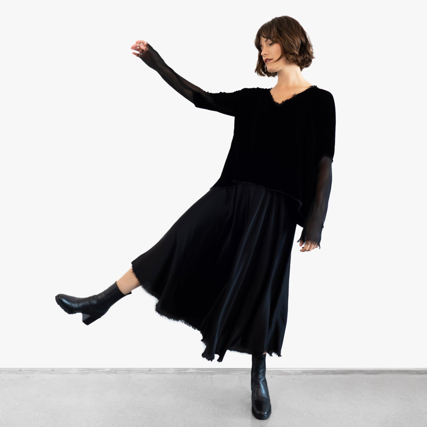Model wearing a black velvet blouse and black silk skirt