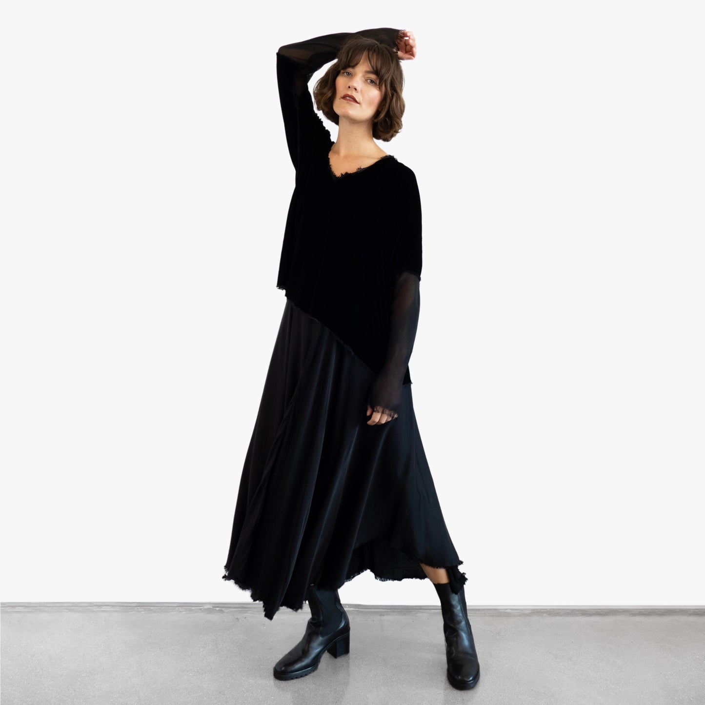 Model wearing a black velvet blouse and black silk skirt