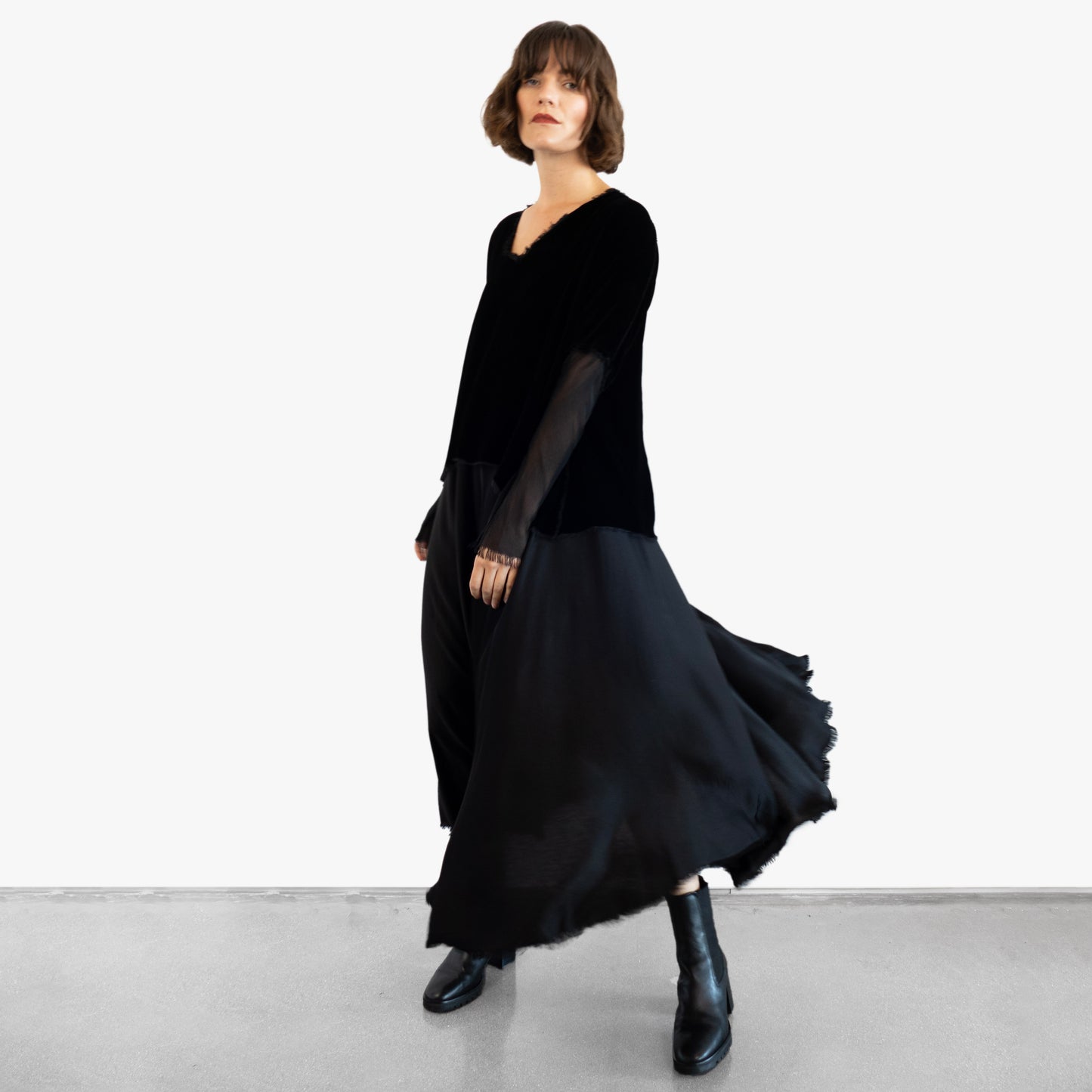 Model wearing a black velvet blouse and black silk skirt