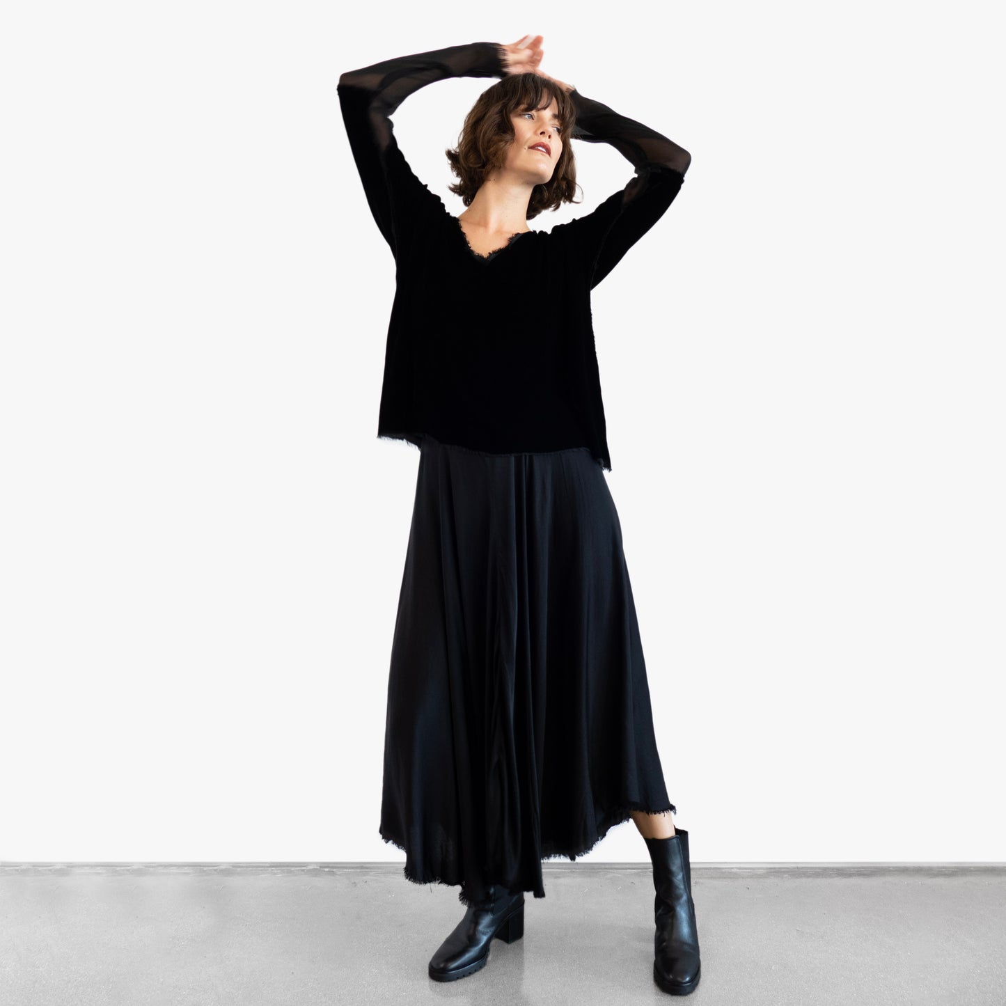 Model wearing a black velvet blouse and black silk skirt