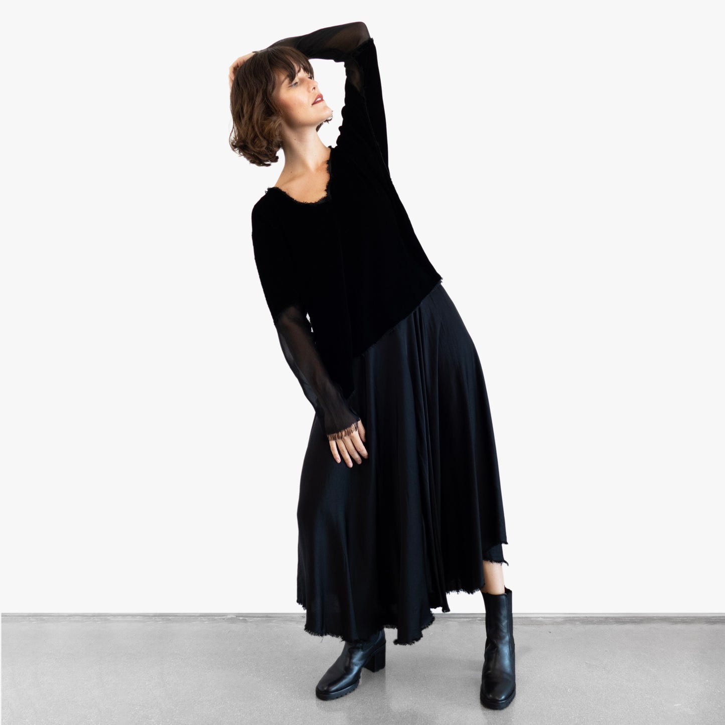 Model wearing a black velvet blouse and black silk skirt