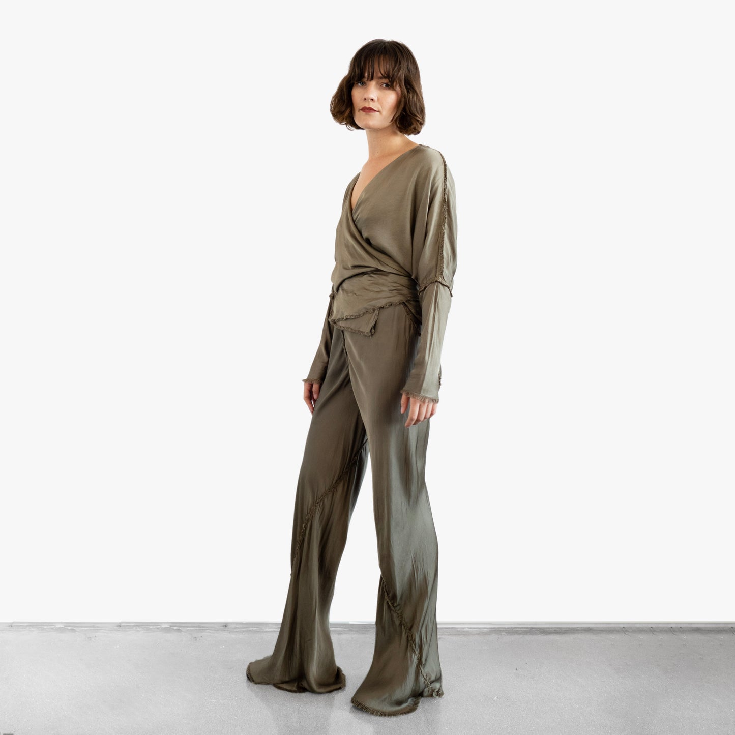 Model wearing a green silk wrap top and pants