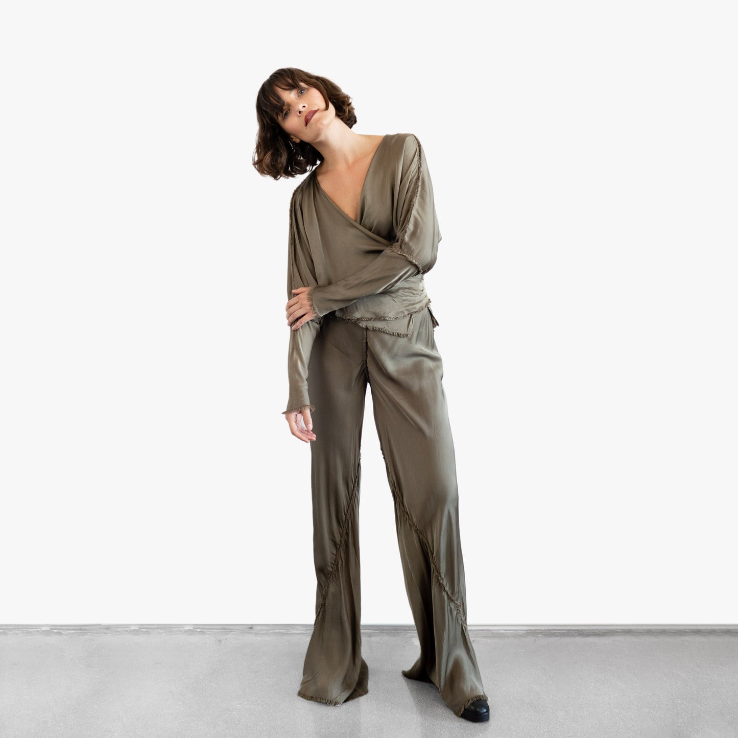 Model wearing a green silk wrap top and pants