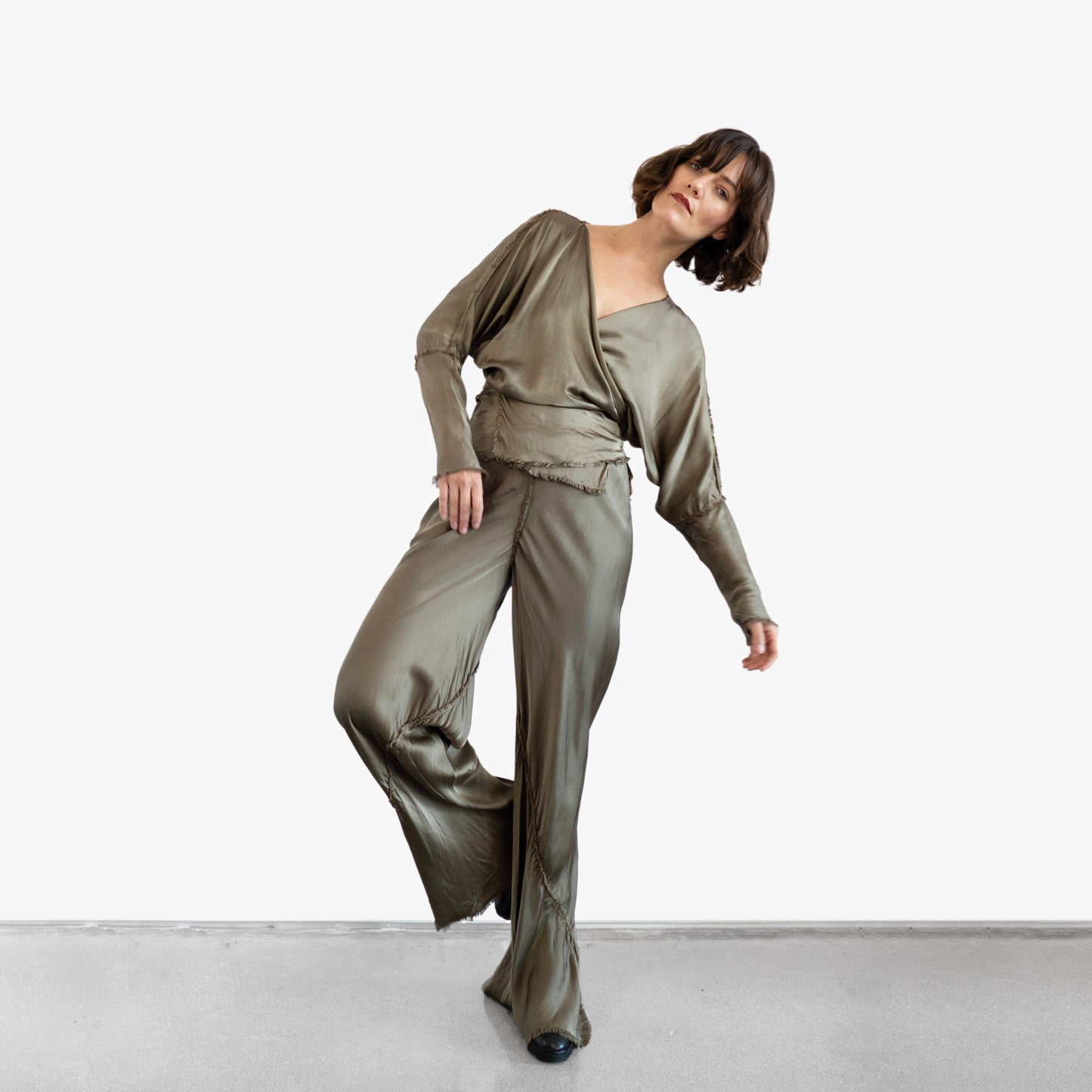 Model wearing a green silk wrap top and pants