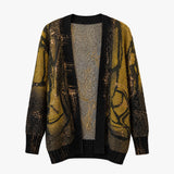 A long-sleeve open-front cardigan featuring a textured black and metallic gold abstract pattern, displayed against a solid white background.