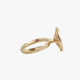 A 14K gold circular cocktail ring set with diamonds around it.