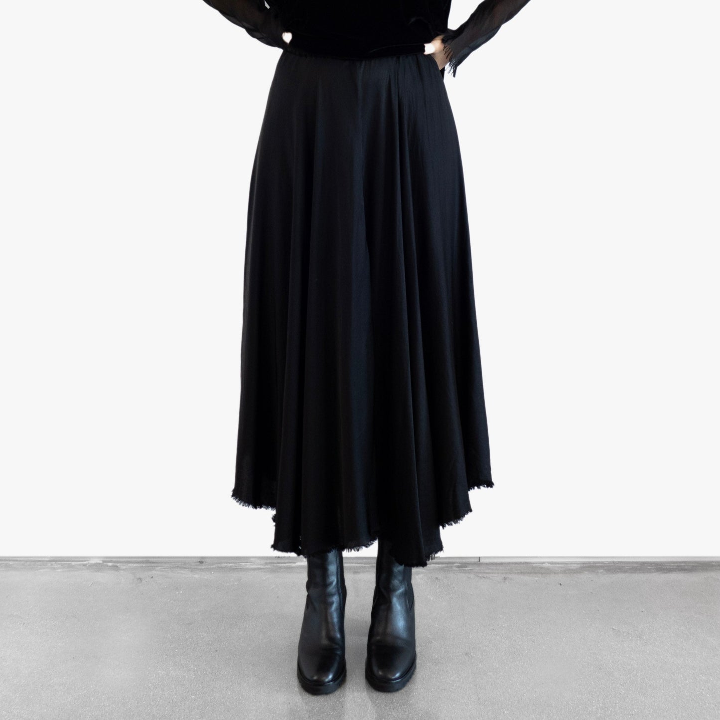 Model wearing a black velvet blouse and black silk skirt