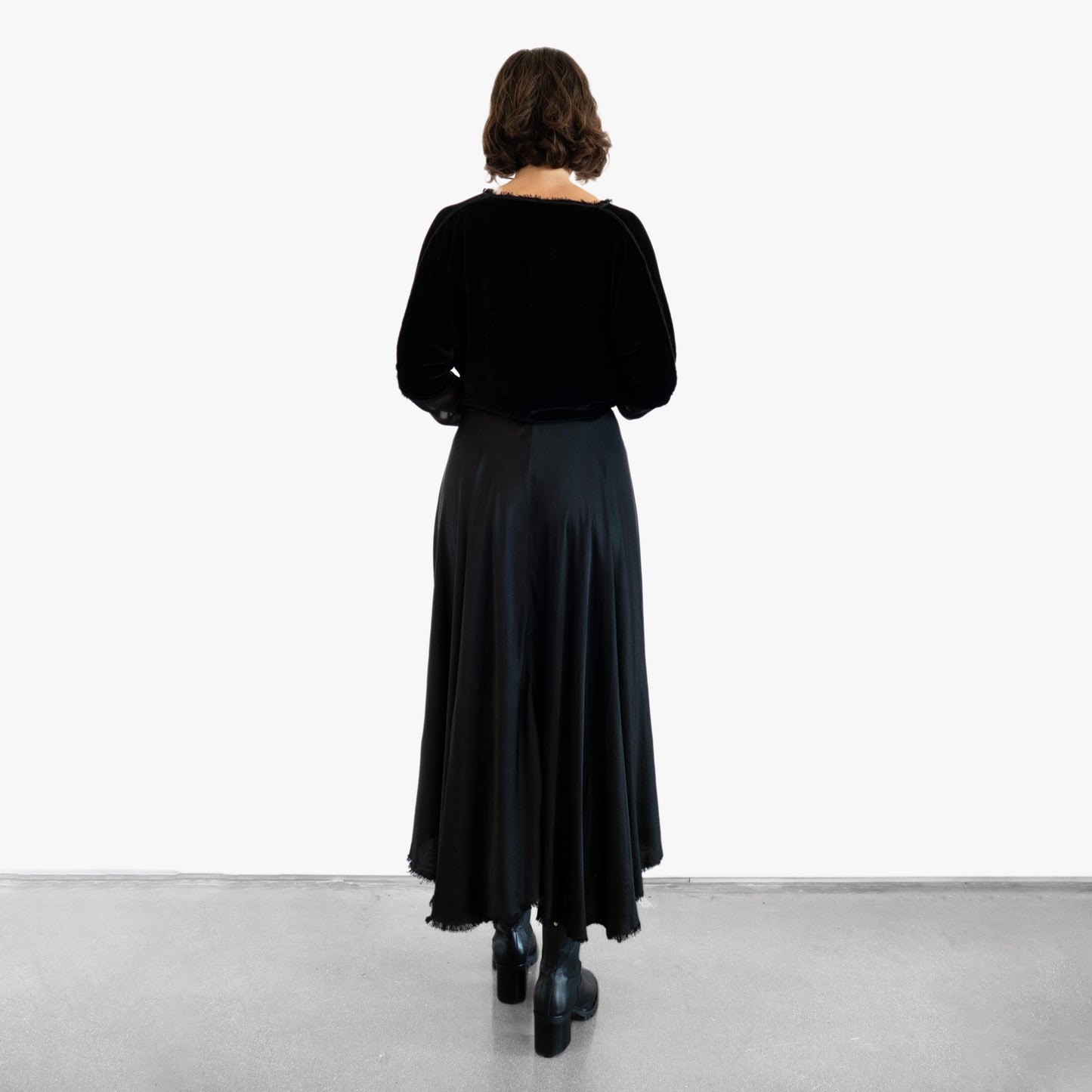 Model wearing a black velvet blouse and black silk skirt