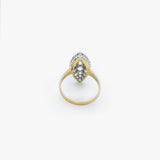 A vintage-style two-tone ring featuring a marquise-cut diamond center stone surrounded by smaller diamonds, set in a yellow gold and silver-tone band, shown on a plain white background.
