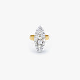 A yellow gold ring featuring a marquise-shaped cluster of clear gemstones, photographed against a clean, light gray background.