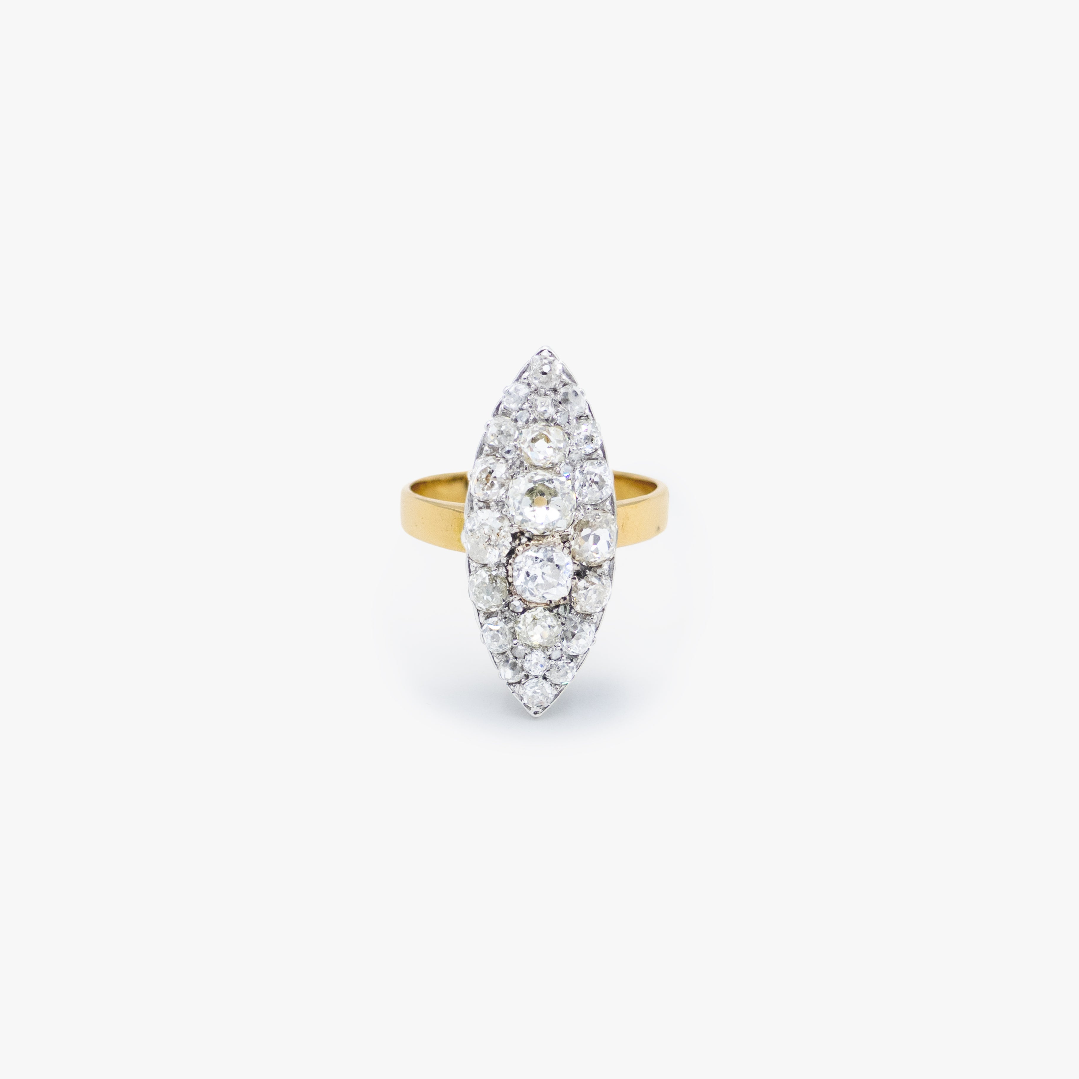 A yellow gold ring featuring a marquise-shaped cluster of clear gemstones, photographed against a clean, light gray background.