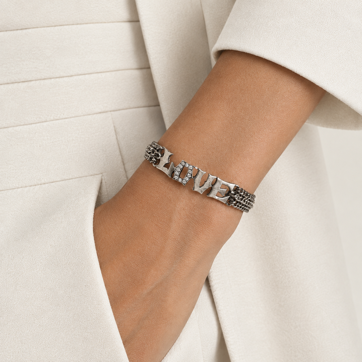a woman wearing a sterling silver and diamond bracelet with her hands in her pocket