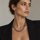 A woman wearing a multi-strand sterling silver necklace with a Tahitian pearl