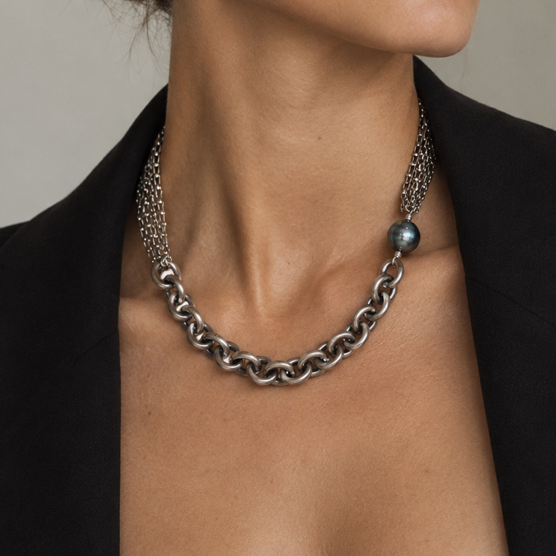 A woman wearing a multi-strand sterling silver necklace with a Tahitian pearl