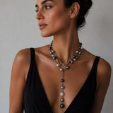a woman wearing a pearl lariat necklace on sterling silver chain