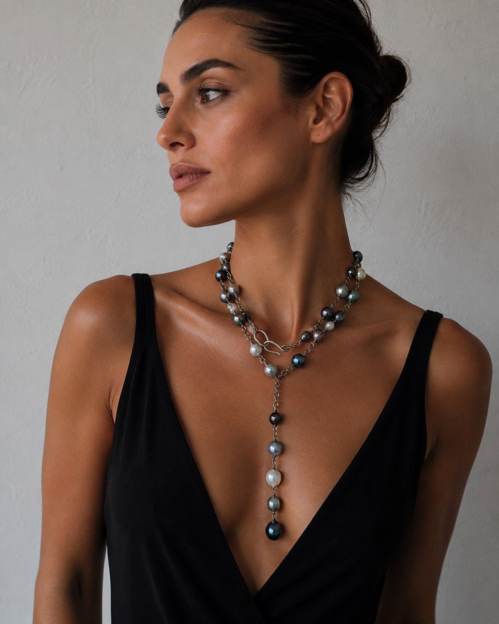 a woman wearing a pearl lariat necklace on sterling silver chain
