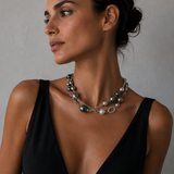A woman wearing a pearl and diamond necklace on a sterling silver chain