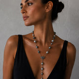 A woman wearing a Tahitian pearl and sterling silver necklace