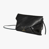 A black leather envelope clutch bag with a small gold-tone logo clasp and a thin black shoulder strap, photographed on a clean white background.