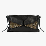 A black leather clutch bag with a unique wing-like flap adorned with gold metallic feathers, set against a plain light gray background.