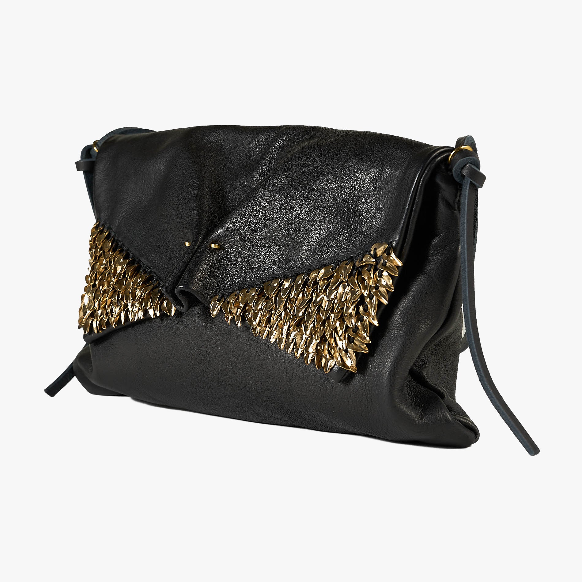 Black leather clutch bag with a gold metallic feather-like embellishment across the front flap, shown on a light gray background.