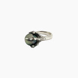 A ring with a Tahitian pearl held in the grip of a sterling silver dragon claw, set with diamond.