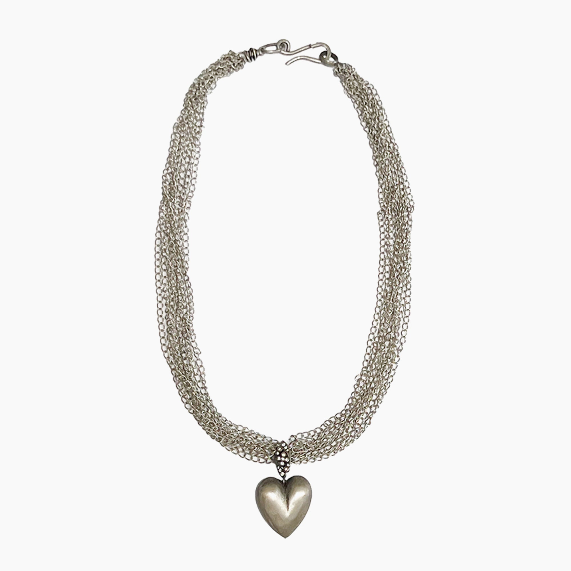 A silver-toned multi-strand chain necklace with a polished heart-shaped pendant, displayed against a clean white background.
