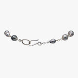 Backing of a pearl lariat necklace on sterling silver chain