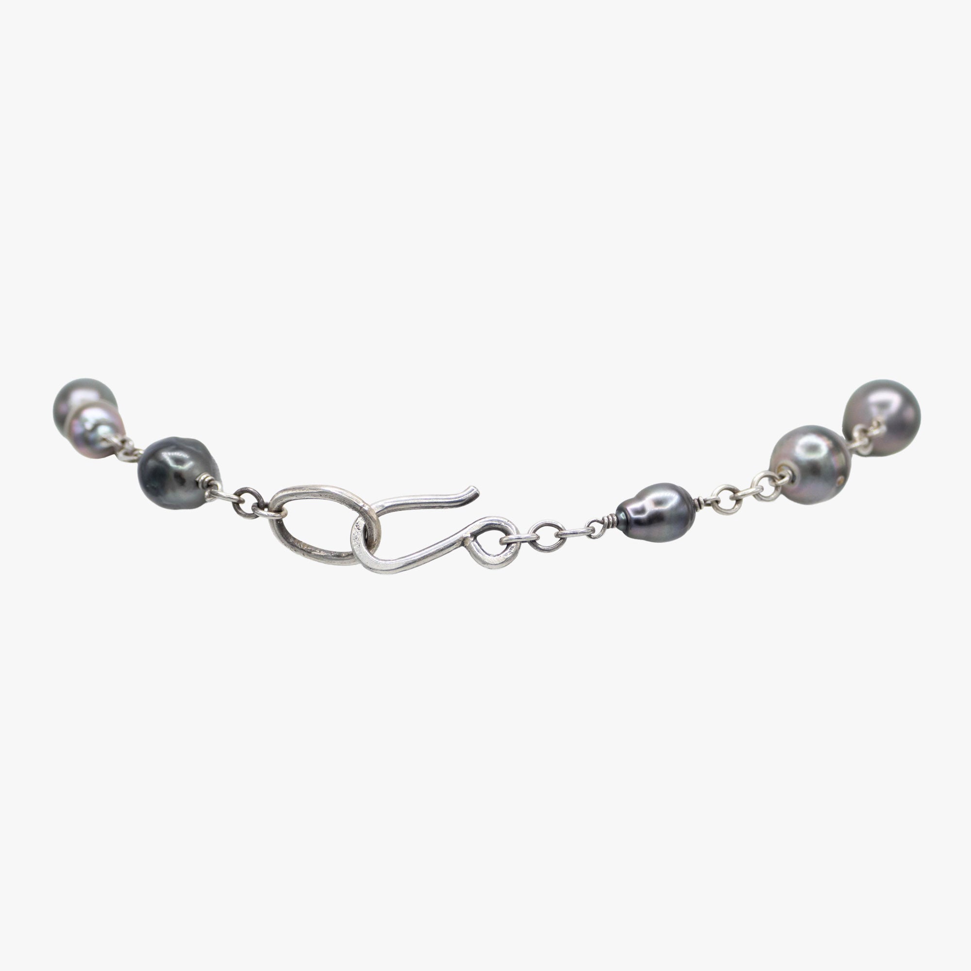 Backing of a pearl lariat necklace on sterling silver chain