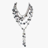 Multiple Tahitian pearl and diamond necklaces layered together