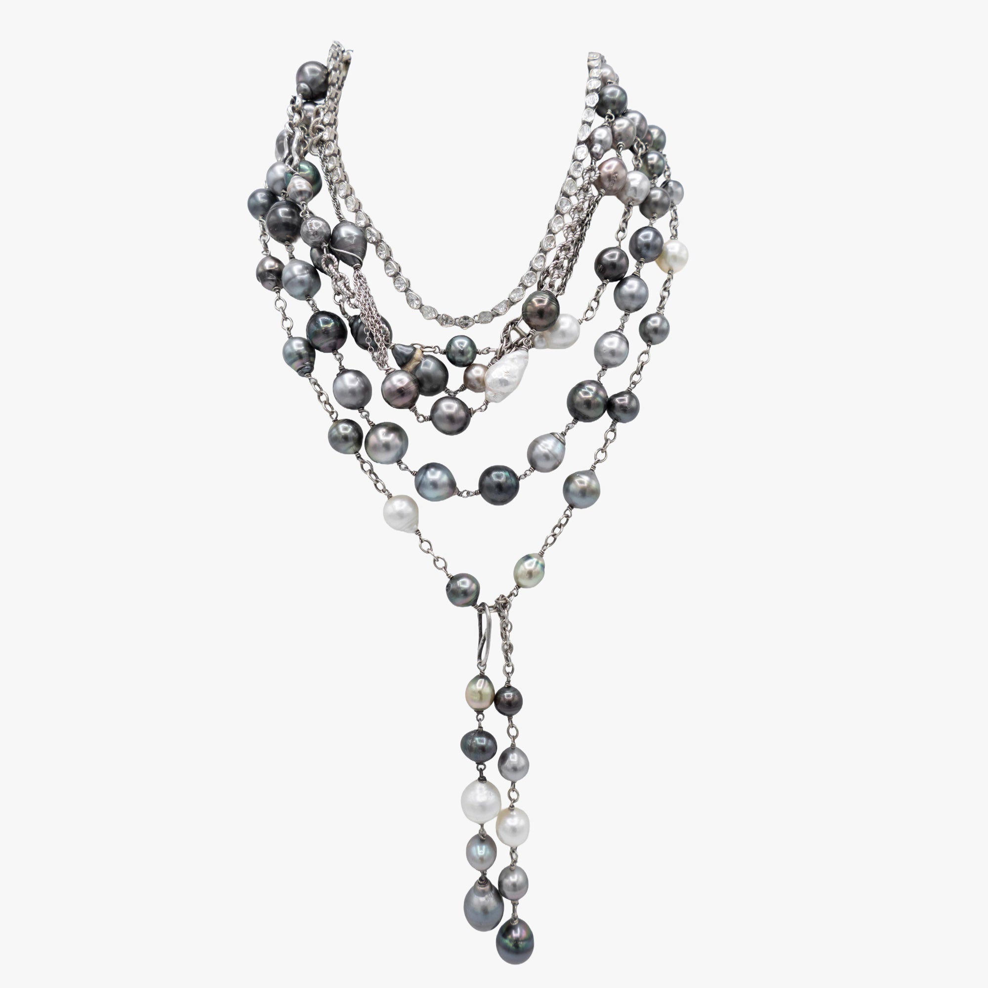 Multiple Tahitian pearl and diamond necklaces layered together