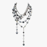 Multiple Tahitian pearl and diamond necklaces layered together