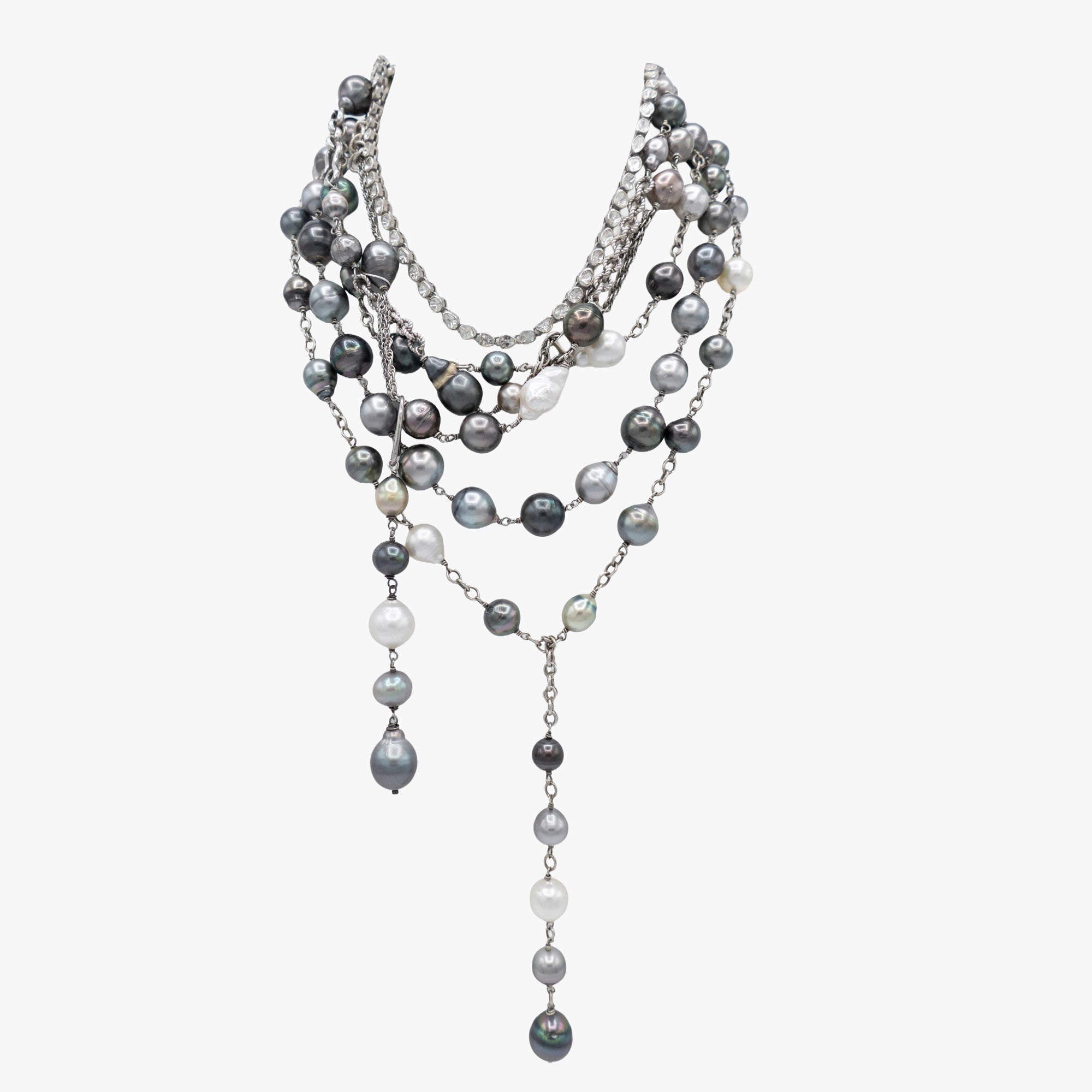 Multiple Tahitian pearl and diamond necklaces layered together