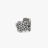 A wide silver cuff ring embellished with multiple rows of diamonds, photographed on a clean white background.