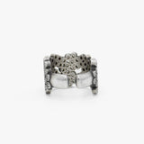 A wide silver cuff ring embellished with multiple rows of diamonds, photographed on a clean white background. 