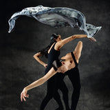 Dancers with a limited edition hand-painted cashmere and silk scarf in gray, black, and white tones with frayed edges and a silver lamination.