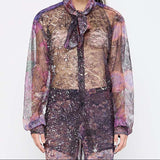 Barbara Bologna Sheer Print Open-Back Blouse — close-up front view, sheer abstract print blouse with neck tie and voluminous sleeves in purple and mauve tones, made in Italy