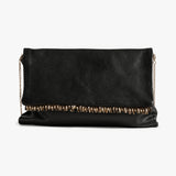 A black envelope clutch bag with a textured finish, featuring a decorative row of gold-toned studs across the front flap and a gold chain strap on either side, shown against a plain white background.