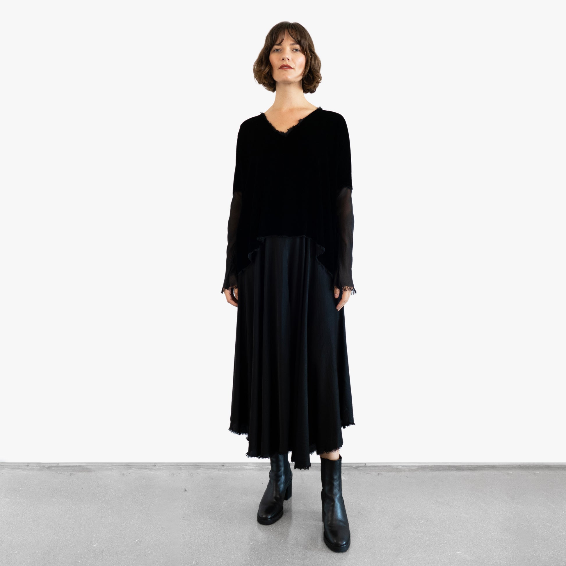 Model wearing a black velvet blouse and black silk skirt