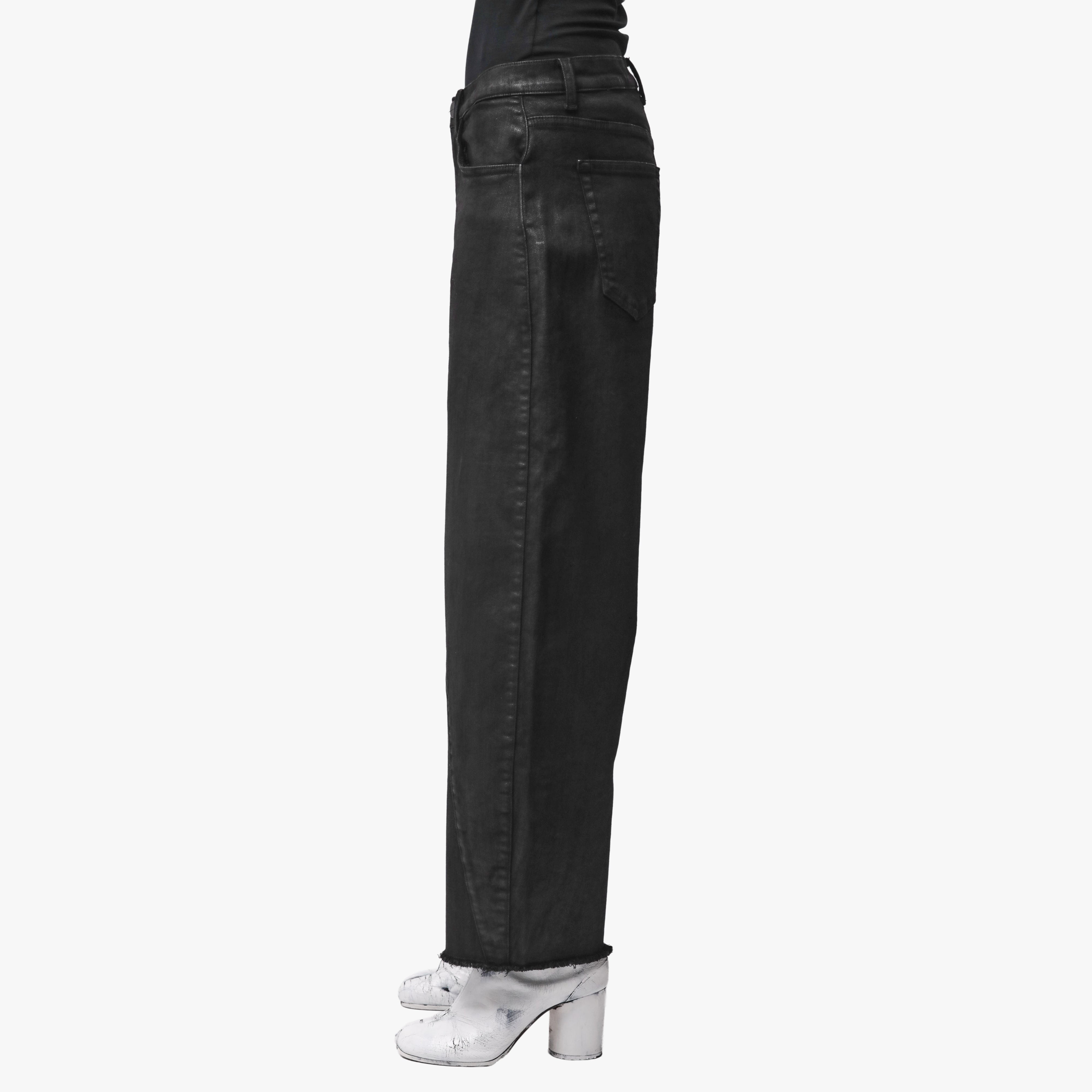 Profile view of a woman wearing black jeans