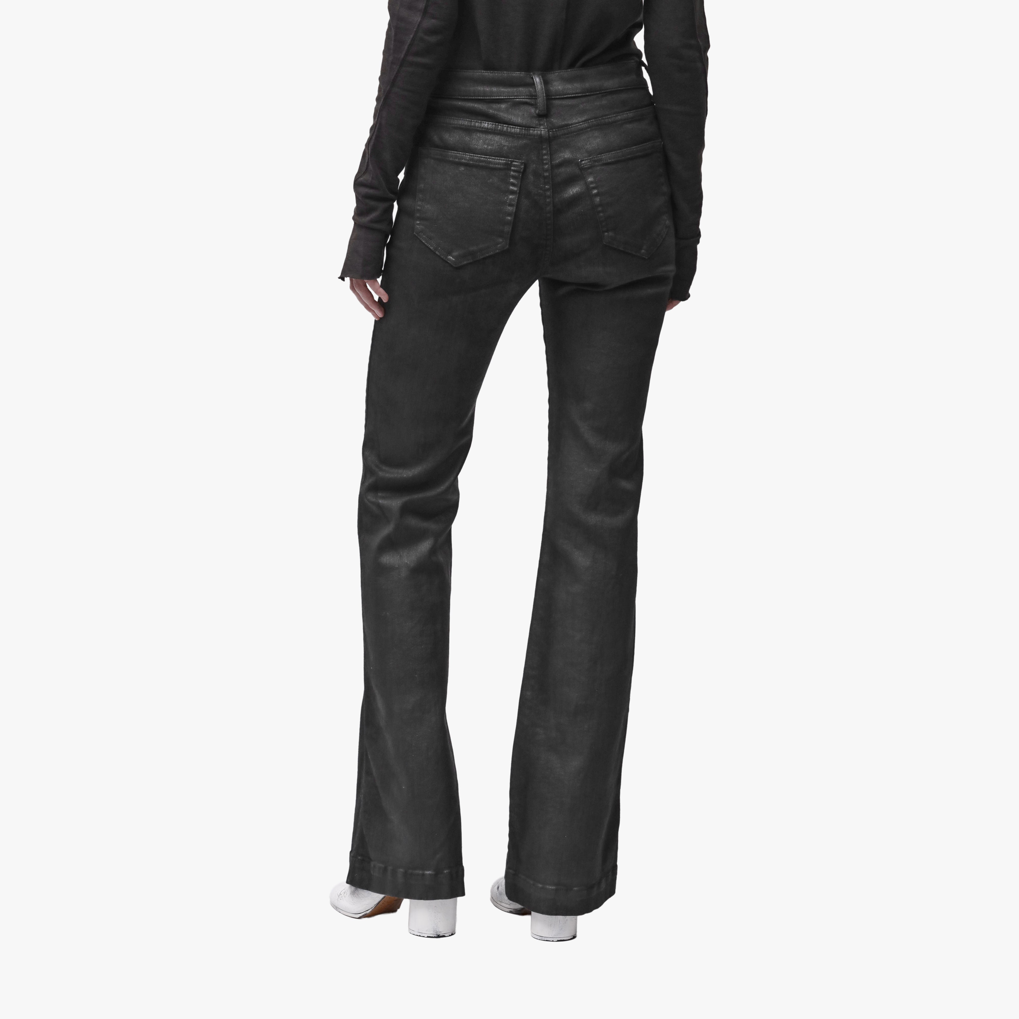 Back view of a woman wearing black flared jeans