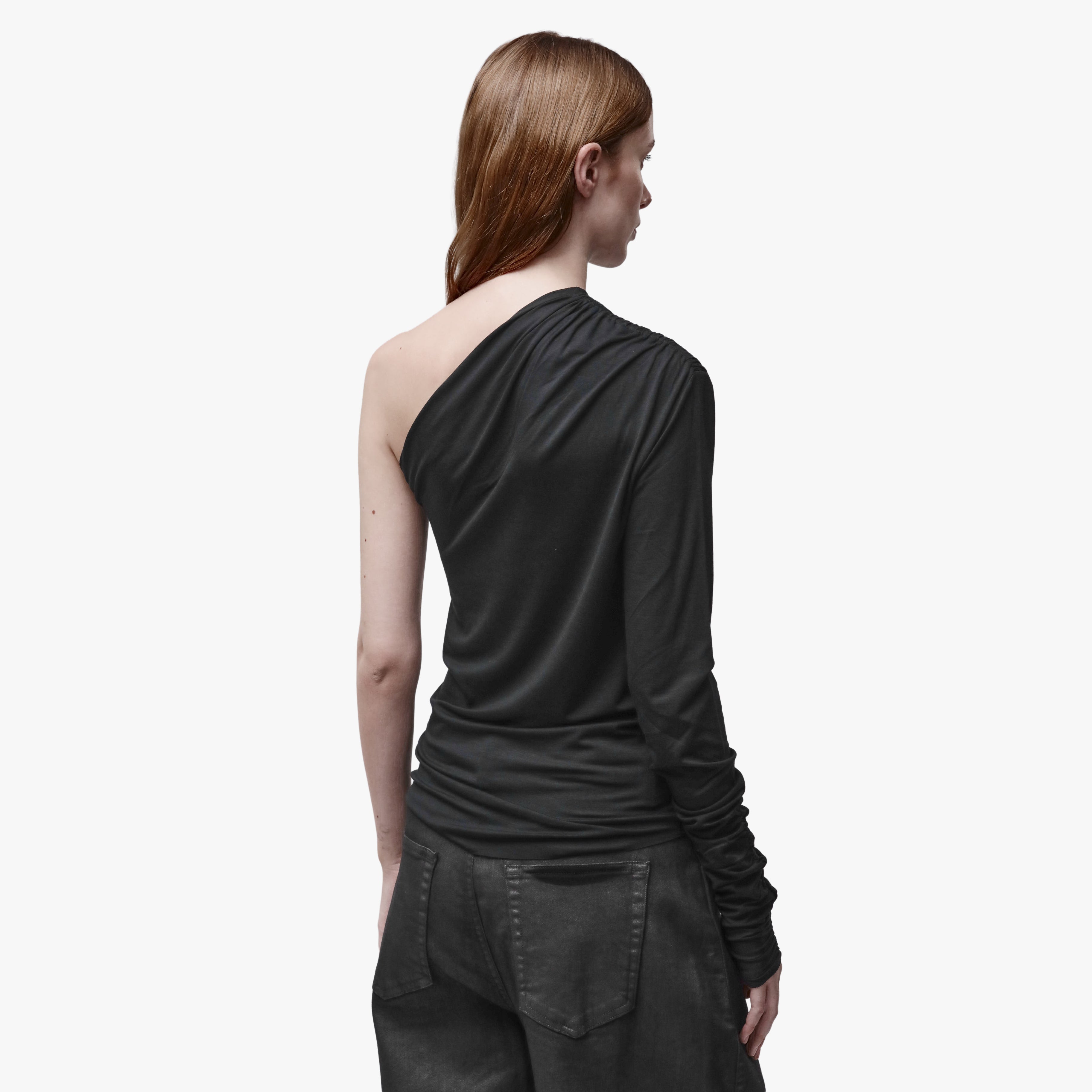 Back view of a woman wearing a black asymmetrical top