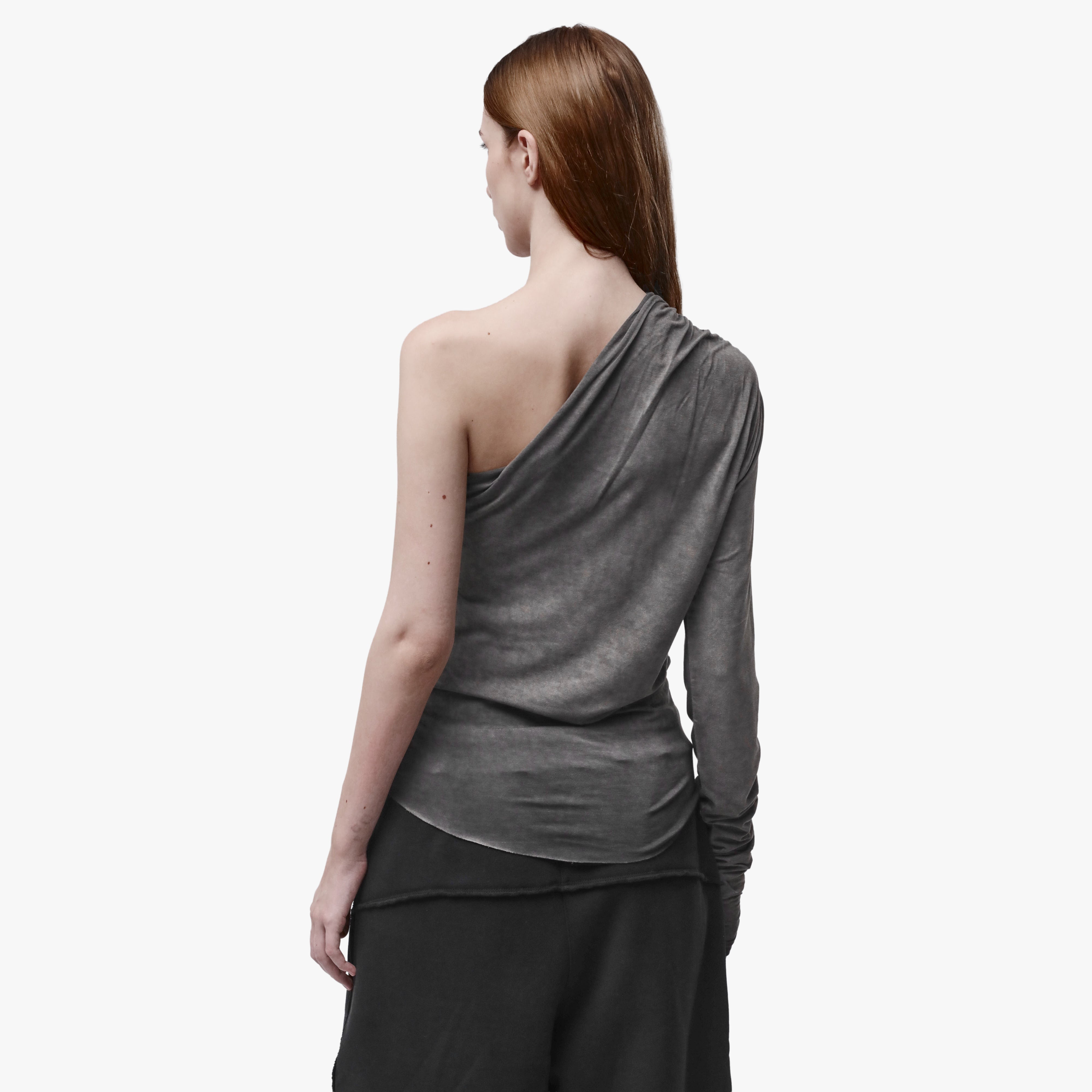Back view of a woman wearing an asymmetrical grey top 