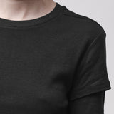 Sleeve detail of a woman wearing a crew neck t-shirt