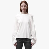 A woman wearing a relaxed white long sleeve crew neck t-shirt